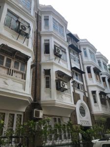 a tall white building with balconies on the side of it at Hebbar's Heritage Home in Mumbai