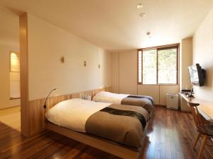 Postel nebo postele na pokoji v ubytování Niseko Konbu Onsen Tsuruga Moku-no-sho