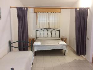 a small bedroom with a bed and a window at Agriturismo Sarrabus in San Priamo