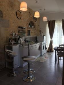 a kitchen with white appliances and a table and chairs at Villa Nature 02 in Meunet-sur-Vatan