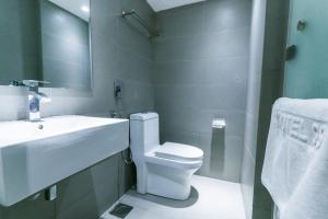 a bathroom with a toilet and a sink and a mirror at Hotel 99 Kepong in Kuala Lumpur +39 photos