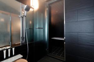 a bathroom with a shower with a glass door at Hotel Gajoen Tokyo in Tokyo
