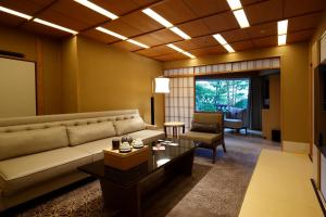 a living room with a couch and a table at Hotel Gajoen Tokyo in Tokyo