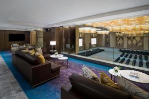 a living room filled with furniture and a large mirror at InterContinental Hotels Jakarta Pondok Indah, an IHG Hotel in Jakarta