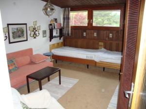 a living room with a bed and a couch at Appartement am Lift in Saalbach Hinterglemm