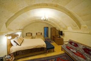 a bedroom with a bed in a room with an arch at Lucky Cave Hotel Cappadocia in Goreme