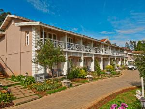 an exterior view of a building at Club Mahindra Derby Green, Ooty in Ooty
