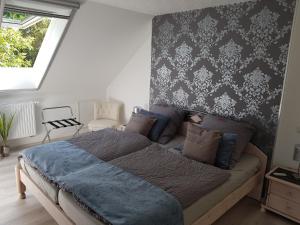 a bedroom with a bed with a blue blanket at Ferienwohnung Am Lindenkrog in Rickert