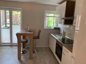 a kitchen with a table and a desk in it at FeWo in Sterkrade in Oberhausen