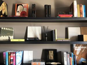 a shelf filled with books and other books at binariouno in Bologna