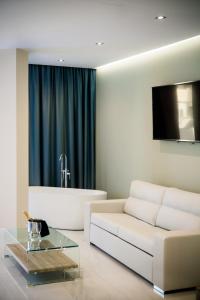 a living room with a white couch and a tv at Los Arcos in Nerja