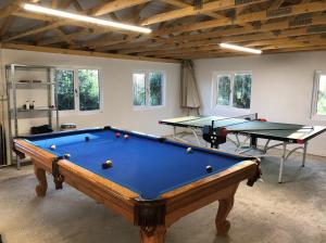 a pool table in a room with two ping pong tables at Downedge in Brading