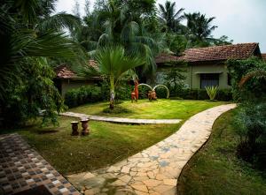 a house with a garden with two animals in the yard at Breathing Earth - Rooms and Pool in Kolkata