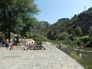 a group of people swimming in a river at Casa Con Encanto En Arnedillo in Arnedillo