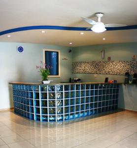 a bar in a lobby with a ceiling fan at Hotel JB in São Mateus