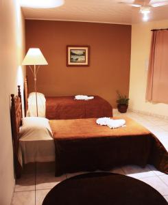 um quarto de hotel com duas camas com toalhas em Hotel JB em São Mateus