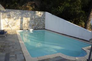 a swimming pool next to a white fence at Villa Pilion in Kolios