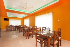 a dining room with wooden tables and chairs at Hotel The Holy Birth in Rummindei