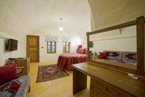 a large room with a bed and a bedroom with a bed sqor at Lucky Cave Hotel Cappadocia in Goreme