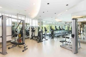a gym with treadmills and ellipticals in a building at Chatrium Hotel Riverside Bangkok in Bangkok