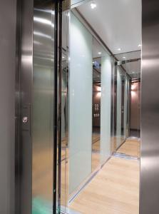 a row of glass elevators in a building at Pergola35 in Florence