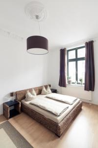 a bedroom with a bed and a large window at Ferienwohnung Leipzig-Zentrum in Leipzig