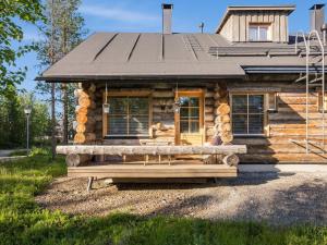 a log cabin with a bench in front of it at Holiday Home Kukasrakka a 4 by Interhome in Äkäslompolo