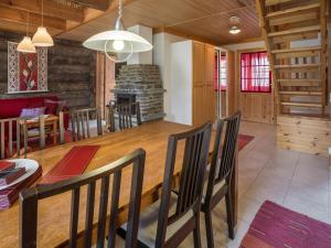 a dining room with a table and a fireplace at Holiday Home Teerentie - poronpesä - g20 by Interhome in Äkäslompolo +11 photos