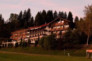 a large building on the side of a hill at Rothenfels Panorama Hotel in Immenstadt im Allgäu