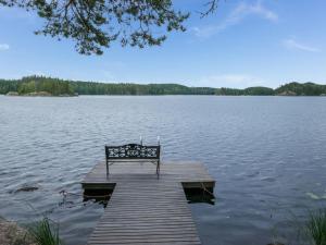 a bench sitting on a dock on a lake at Holiday Home Neitlinna by Interhome in Pitkälahti