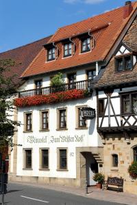 a large white building with a sign on it at Weinkastell Zum Weissen Ross in Kallstadt