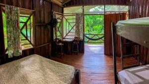 an inside view of a room with a bed and windows at Sukia Hostel in Drake