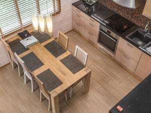 an overhead view of a kitchen with a wooden table and chairs at Holiday Home Villa illi by Interhome in Tahkovuori