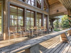 a porch of a cabin with chairs and tables at Holiday Home Ylläskyrö by Interhome in Ylläsjärvi +28 photos