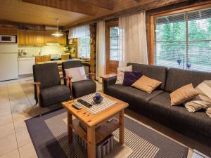a living room with a couch and a table at Holiday Home Kukasrakka a 4 by Interhome in Äkäslompolo +13 photos
