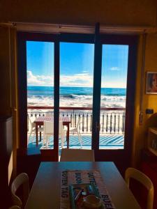 a dining room with a view of the ocean at Dimora di Toosa - Near Taormina in Riposto