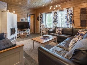 a living room with a couch and a coffee table at Holiday Home Tuulenpuuska by Interhome in Äkäslompolo