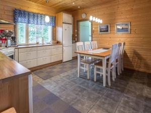 a kitchen with a table and chairs in a room at Holiday Home Tuulenpuuska by Interhome in Äkäslompolo