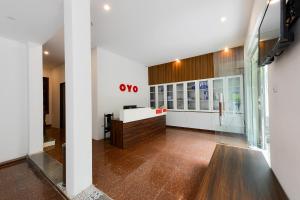 a kitchen with white cabinets and a refrigerator at OYO 317 Kim Cuong Hotel 2 in Hanoi