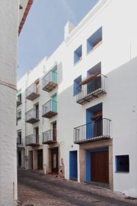 a white building with balconies on a street at Estudio Casco Antiguo Inmomart in Peniscola