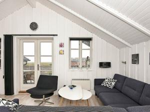 a living room with a couch and a table at 4 person holiday home in R m in Rømø Kirkeby
