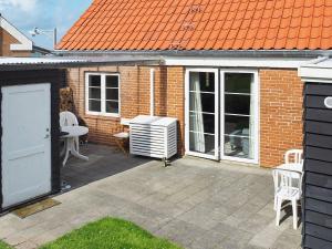 a patio with a heater and a table and chairs at 6 person holiday home in Lemvig in Lemvig