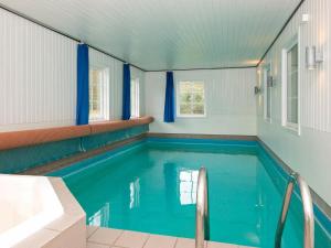 einen Pool in einem Zimmer mit Badewanne und Waschbecken in der Unterkunft 10 person holiday home in R m in Toftum