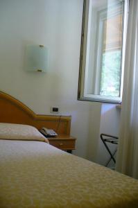 a bedroom with a bed and a window at Hotel Villa La Marticana in Ischia