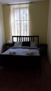 a bedroom with a bed with two towels on it at Sopron City Apartment in Sopron +5 photos