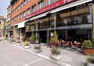 a store front of a building with potted plants outside at Konačište Grad B&B in Užice