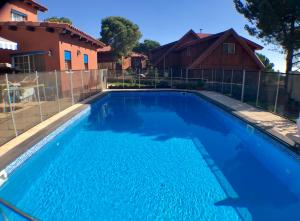 a large blue swimming pool in front of a house at zimmer cigale in Odem
