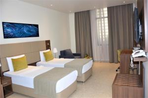 Giường trong phòng chung tại Capital Hotel Djibouti