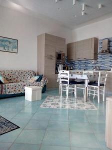 a kitchen and living room with a table and chairs at MARGIE'S HOUSE in Procida