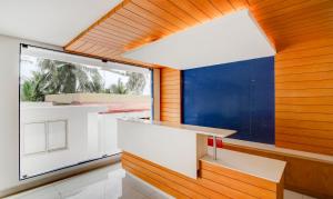 a kitchen with wooden walls and a large window at Cilantro By The Sea in Kovalam
